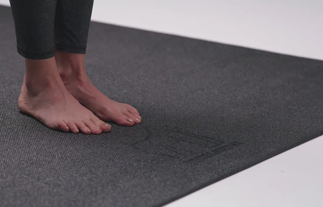 Bare feet on a dark mat in a photo studio
